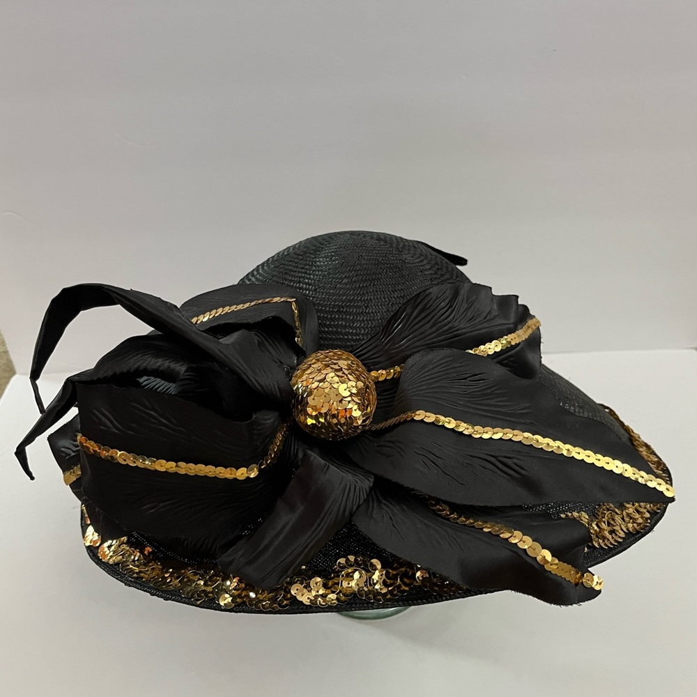 THIS BEAUTIFUL VINTAGE GOLD AND BLACK HAT IS SURE TO MAKE HEADS TURN.